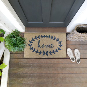 Wide view of the Home Wreath doormat showing its coarse coir texture and printed design