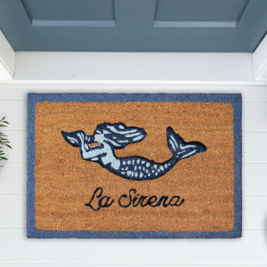 La Sirena coir doormat with a blue mermaid, script lettering and blue border at a blue-grey door