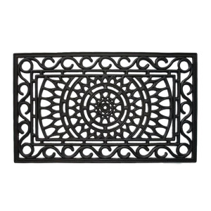 Black rectangular rubber doormat with an ornamental openwork scroll pattern