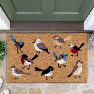 Close-up of a natural coir doormat with nine colourful illustrated birds beside a green front door