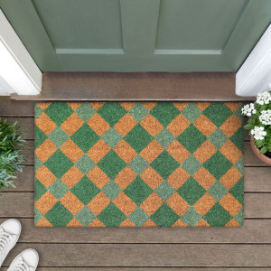 Green diamond doormat at a green door, styled with leafy plants, white flowers and white shoes