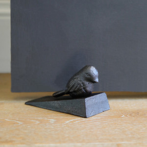 Brambling Bird Door Wedge, a decorative floor accent made to keep a door securely positioned