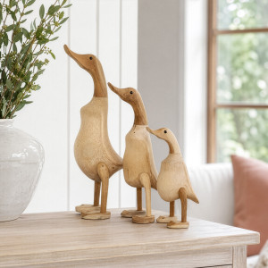 Set of three natural wooden ducks with closed beaks