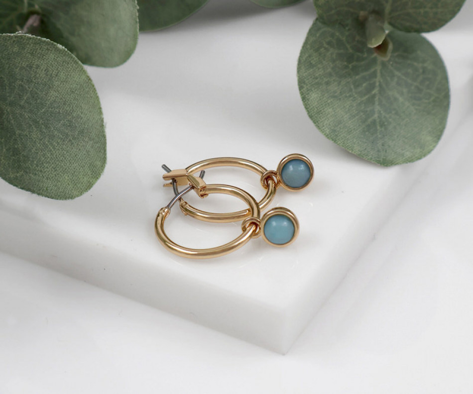 Sasha Gold Huggies with London Blue Stone, highlighting the product's distinctive form and defining design
