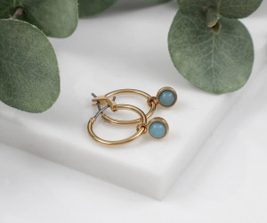 Sasha Gold Huggies with London Blue Stone, highlighting the product's distinctive form and defining design