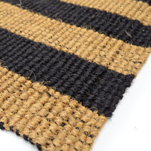 Close up of woven natural and black striped indoor doormat