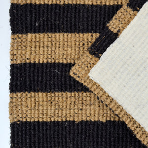 Underside view of chunky black striped indoor mat
