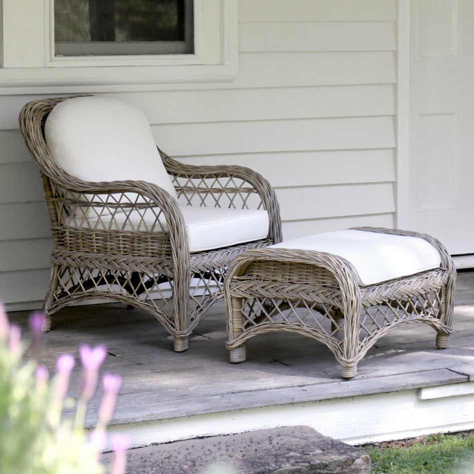 Camden rattan footstool paired with its matching armchair on a covered porch