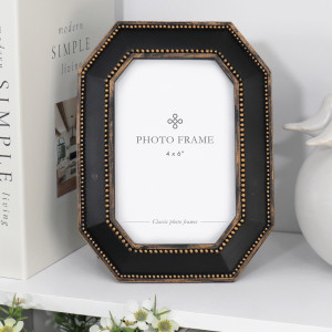 Octagonal black 4x6 photo frame with antique gold-toned beading displayed on a white shelf