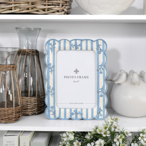 Bluebell scalloped 5x7 photo frame styled with woven glass jugs and white ceramic décor on a shelf.