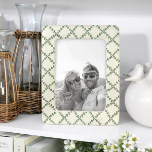 Juniper Lattice 5x7 photo frame styled with wicker-wrapped glass jugs and white ceramic décor on a shelf.