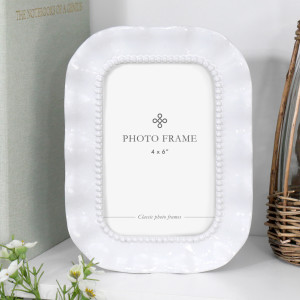 Glossy white Sabina 4x6 photo frame with softly ruffled edges and a raised beaded inner border.