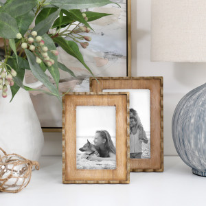 Marielle 4x6 and 5x7 inch wood frames with black-and-white photos, styled with foliage and a lamp