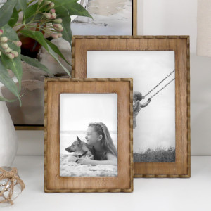 Coordinating Marielle wood frames displaying black-and-white photos, with scalloped edging and rustic finishes