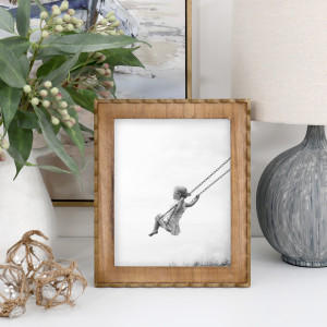Marielle wood frame displaying a black-and-white photo of a child on a swing, beside foliage and a lamp