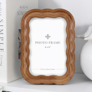 Warm brown wood-look 4x6 photo frame with layered wavy edges displayed upright on a white shelf.