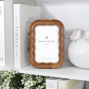 Ralston Curve 4x6 photo frame styled with books, white ceramic décor and flowers on a shelf.