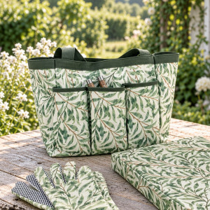 Close-up of Greenhaven gardener's bag with green leaf print, dark green trim and three front pockets