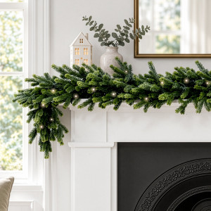 Forest Glow green Christmas garland with glowing LED lights draped over the corner of a white mantel