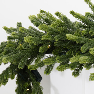 Forest Glow light-up Christmas garland across a white mantel beneath a gold-framed mirror