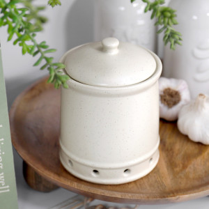 Darley Cream Ceramic Garlic Vault with domed lid and ventilation holes styled on a wooden riser