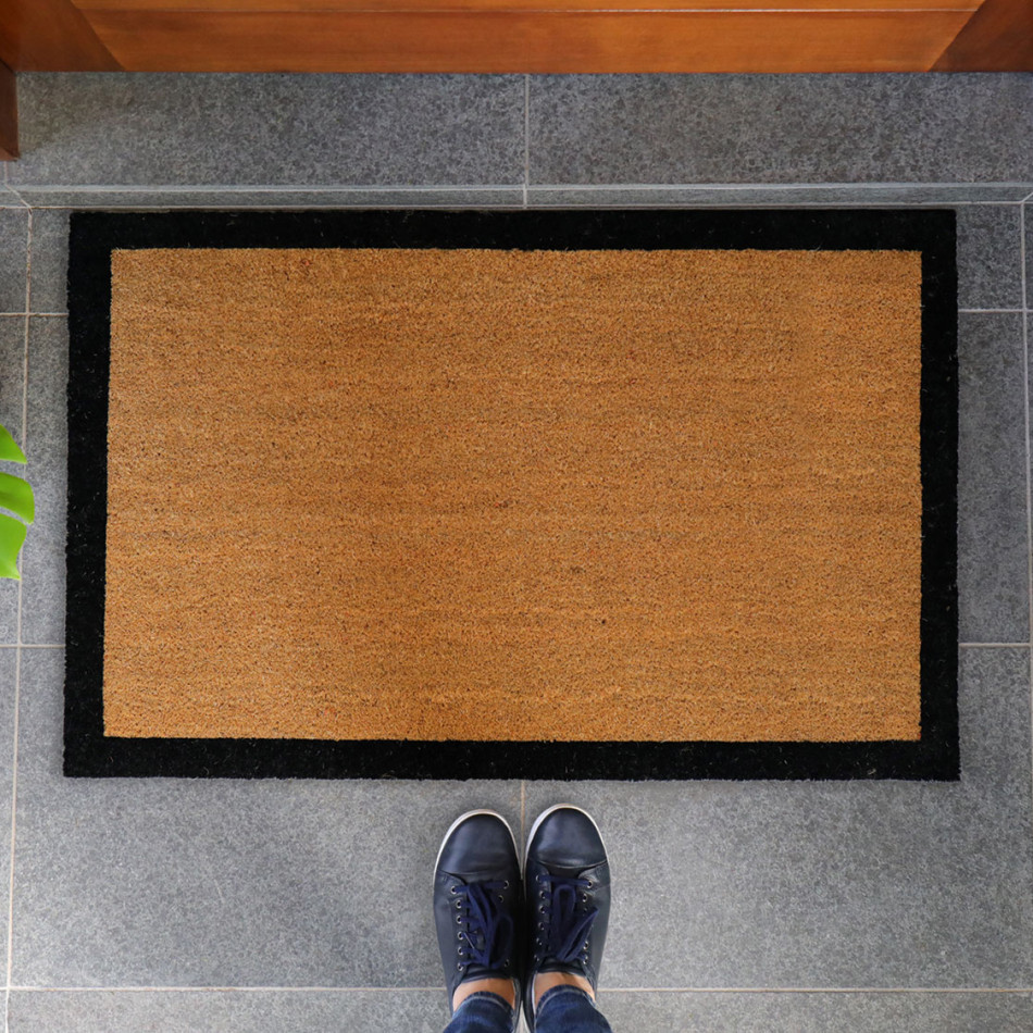 Large natural coir doormat with a contrasting black border