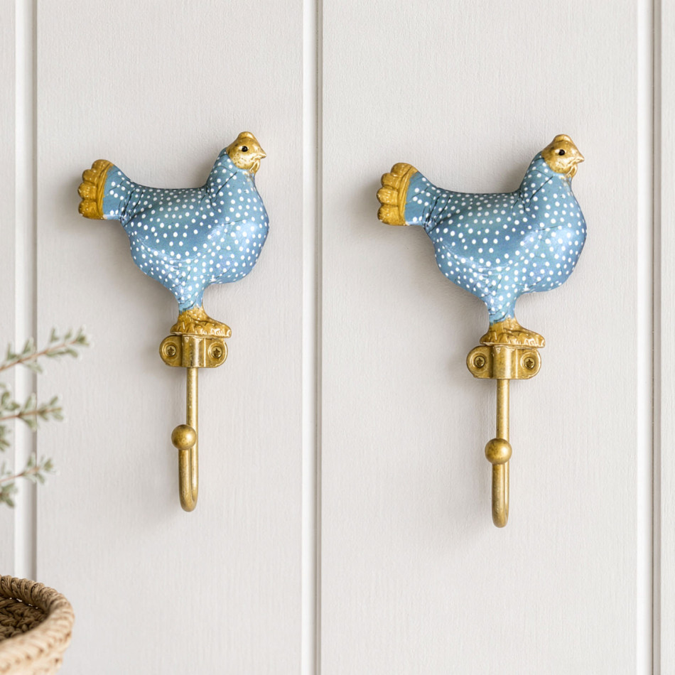Pair of blue Maisie chicken wall hooks displayed together on white wall panelling