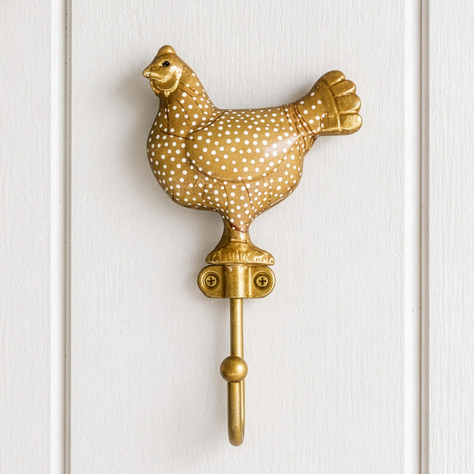 Yellow Maisie chicken wall hook with white spots mounted on white wall panelling