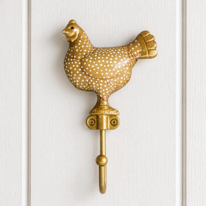Yellow Maisie chicken wall hook with white spots mounted on white wall panelling