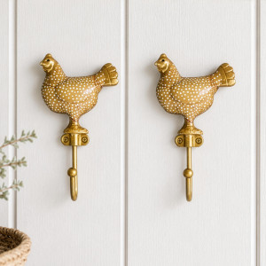Pair of yellow Maisie chicken wall hooks displayed together on white panelling