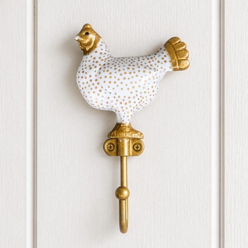 White Maisie chicken wall hook with gold spots and details mounted on white wall panelling