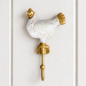 White Maisie chicken wall hook with gold spots and details mounted on white wall panelling