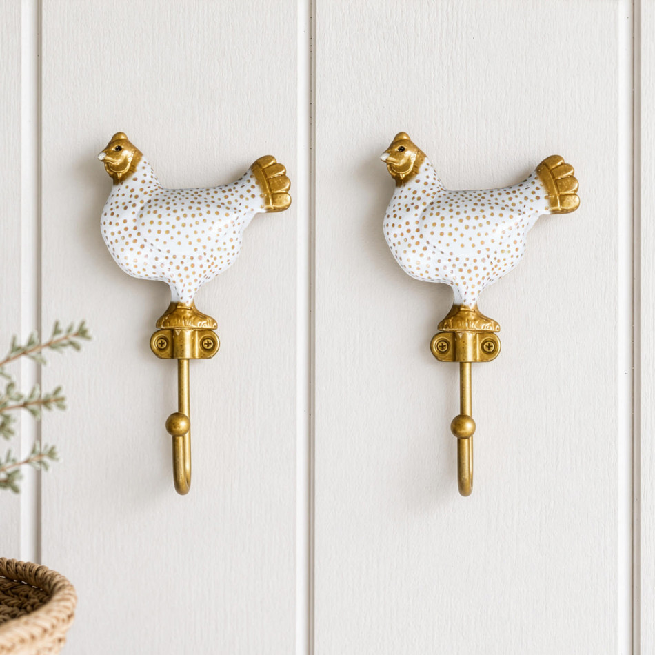Pair of white Maisie chicken wall hooks displayed together on white panelling