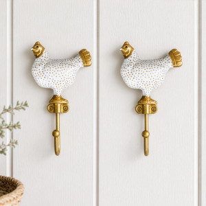 Pair of white Maisie chicken wall hooks displayed together on white panelling