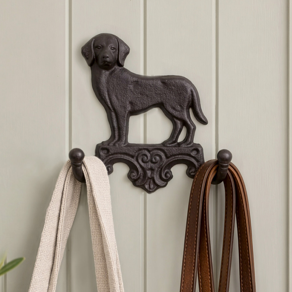 Dark brown cast iron Labrador wall hook holding a cream bag and brown dog leads