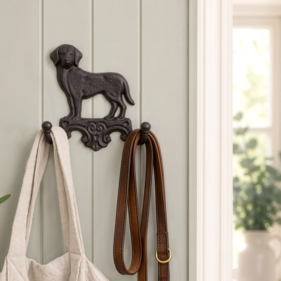Dark brown Labrador wall hook mounted on a panelled entryway wall with a bag and dog leads