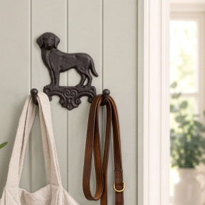 Dark brown Labrador wall hook mounted on a panelled entryway wall with a bag and dog leads