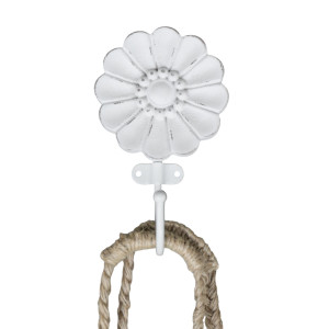 White floral wall hook holding a natural woven rope accessory