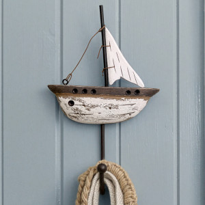 Rustic reclaimed wood yacht wall hook mounted on blue panelling and holding woven accessories