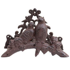 Front view of brown cast iron hose holder with two birds on a leafy branch and decorative scrollwork