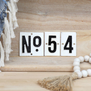 Set of white cast iron wall signs with black numbering