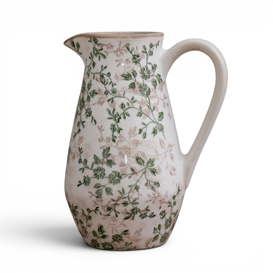Front view of the Evergreen floral ceramic jug with curved handle and pouring spout on white