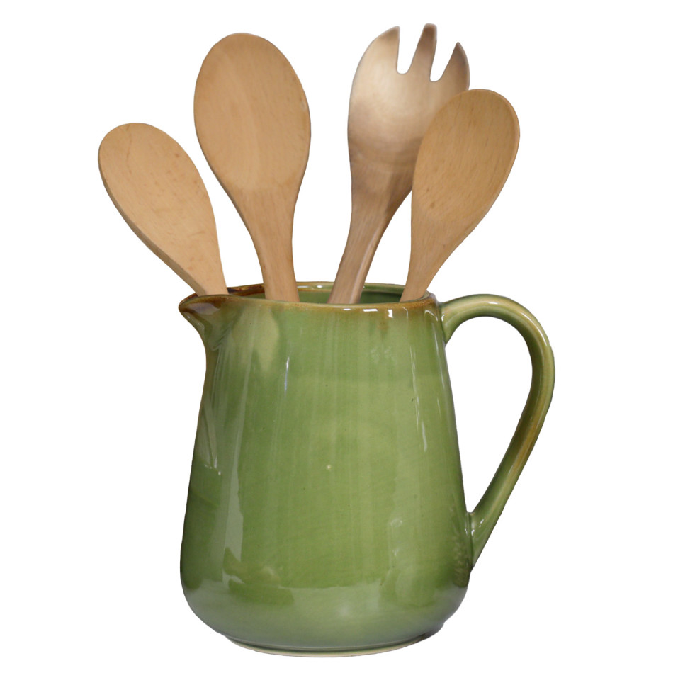 Green reactive-glaze ceramic jug holding four wooden kitchen utensils on a white background.