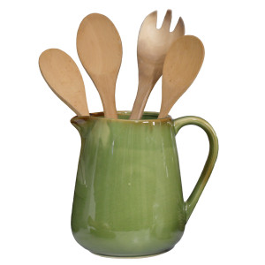 Green reactive-glaze ceramic jug holding four wooden kitchen utensils on a white background.