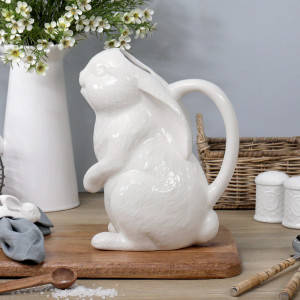 White ceramic rabbit-shaped jug sitting on a chopping board