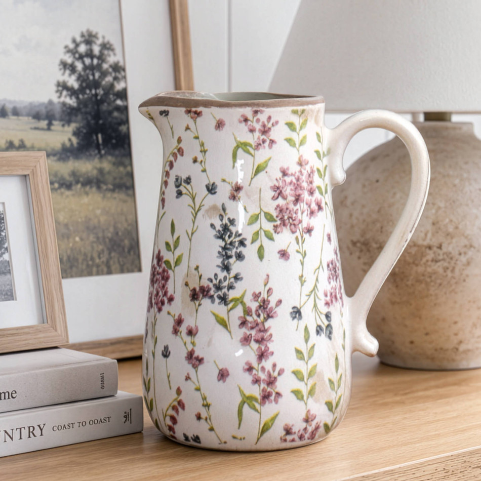 Rosewood floral ceramic jug styled on a timber console beside framed landscape prints and a neutral lamp