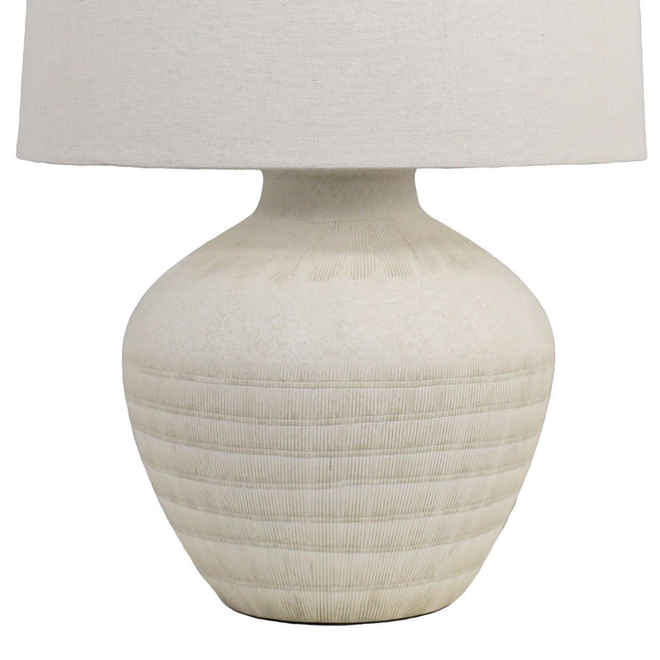Close-up of the Fernando lamp’s cream ceramic base with horizontal bands of fine textured dashes
