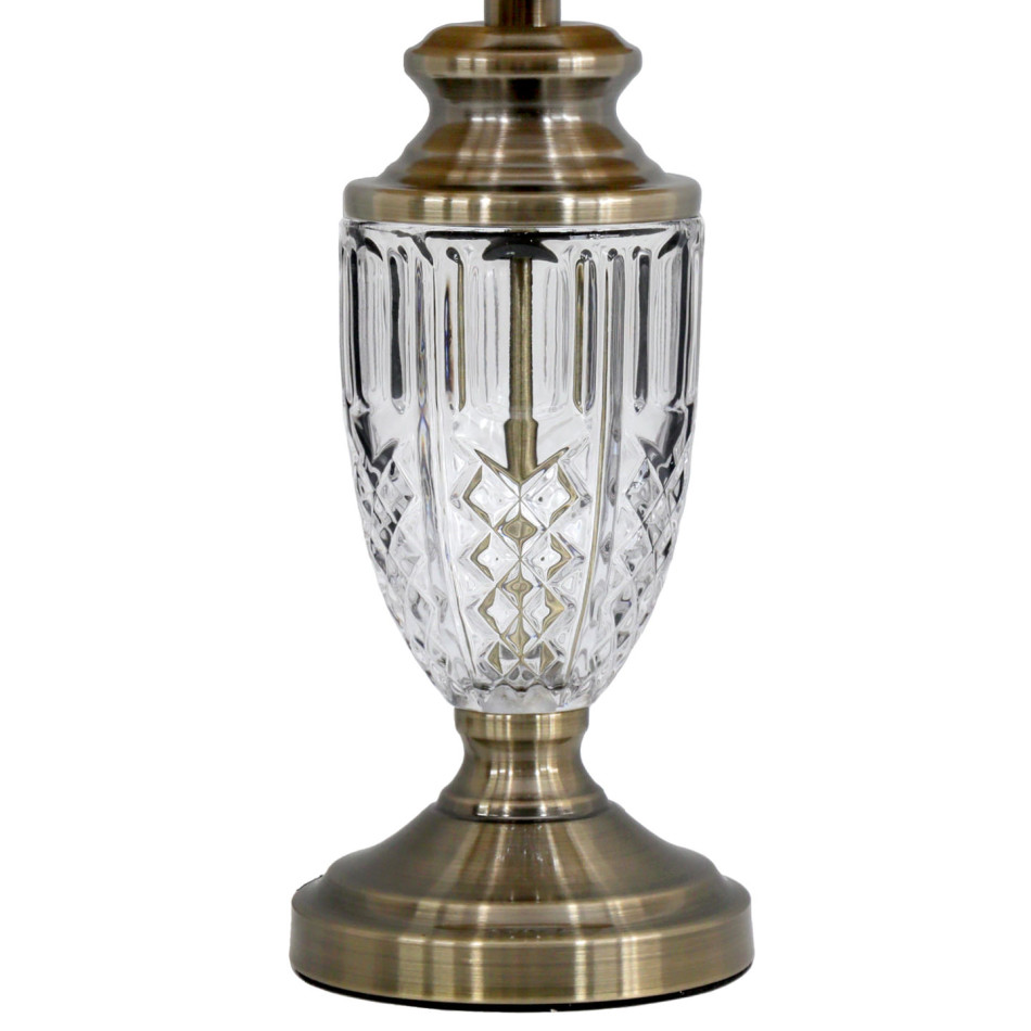 Close-up of the Molisana lamp’s patterned clear glass body and antique gold pedestal base