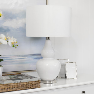 Paloma white table lamp styled on a console with neutral accessories