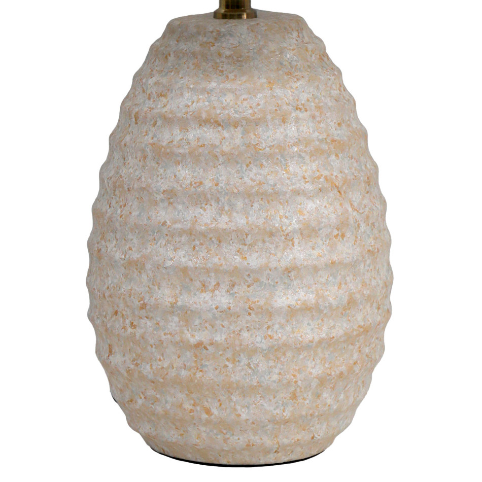 Close-up of the lamp’s ceramic base showing horizontal ripples and a mottled beige and off-white finish